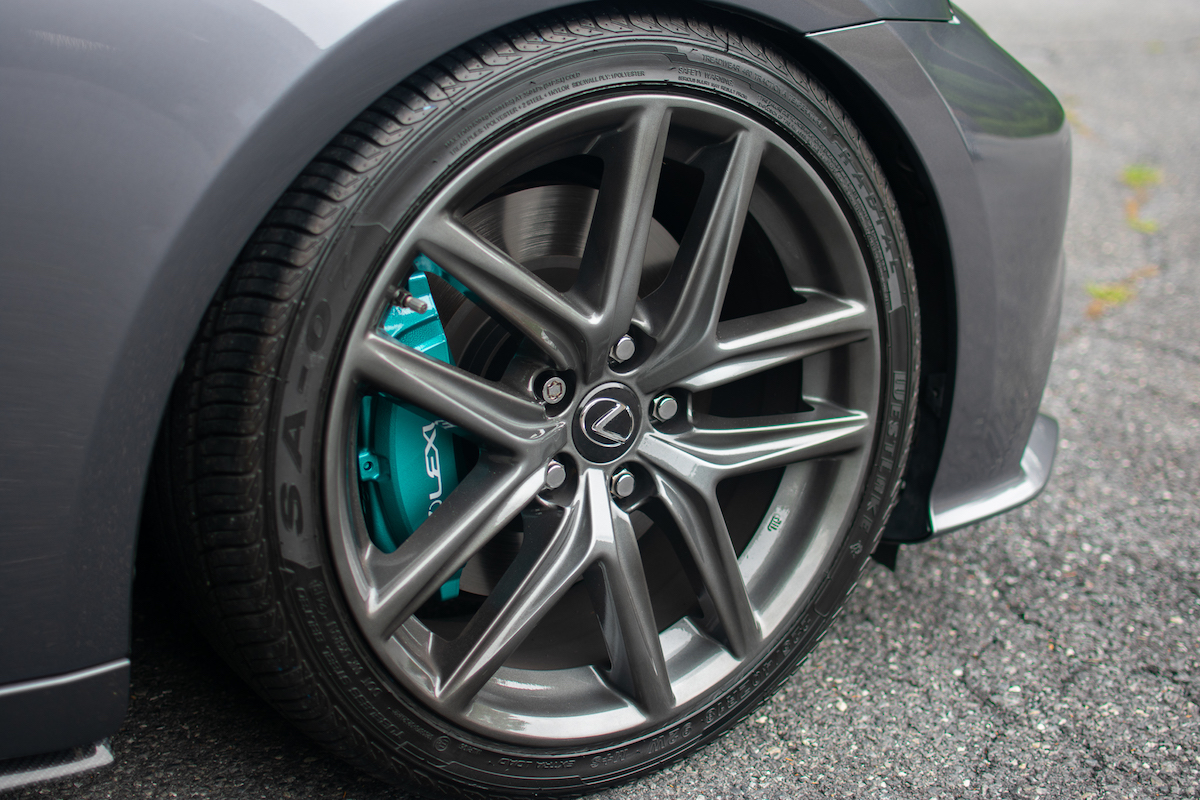 Close up of custom painted brake calipers on a Lexus.
